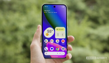 Someone holding the Google Pixel 10 with its screen on, showing the home screen.