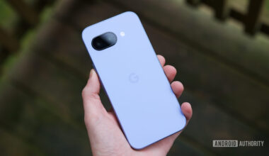 Someone holding the Pixel 9a, showing the back of the phone.