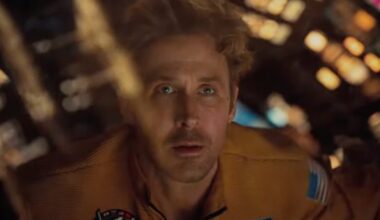 closeup of blond man in a spacesuit peering out through a window of his spacecraft in wonder