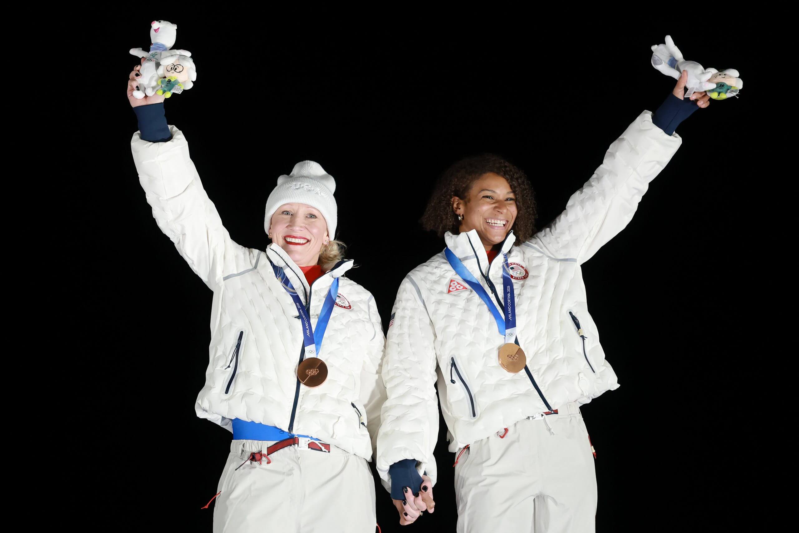Bronze medalists Kaillie Armbruster Humphries and Jasmine Jones of Team United States celebrate on the podium during the medal ceremony for the Bobsleigh Two-Woman on day fifteen of the Milano Cortina 2026 Winter Olympic games at Cortina Sliding Centre on February 21, 2026 in Cortina d'Ampezzo, Italy. 
