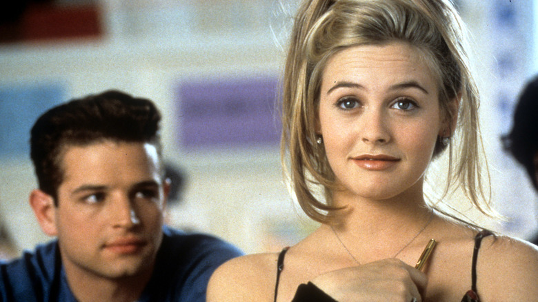 Cher Horowitz looking ahead as a guy behind her stares at her in 