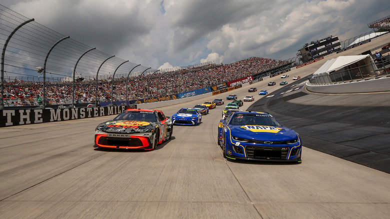 Chase Elliott, driver of the #9 NAPA Auto Parts Chevrolet, and Chase Briscoe, driver of the #19 Bass Pro Shops Toyota, lead the field on a pace lap prior to the NASCAR Cup Series AutoTrader EchoPark Automotive 400 at Dover Motor Speedway on July 20, 2025 in Dover, Delaware.