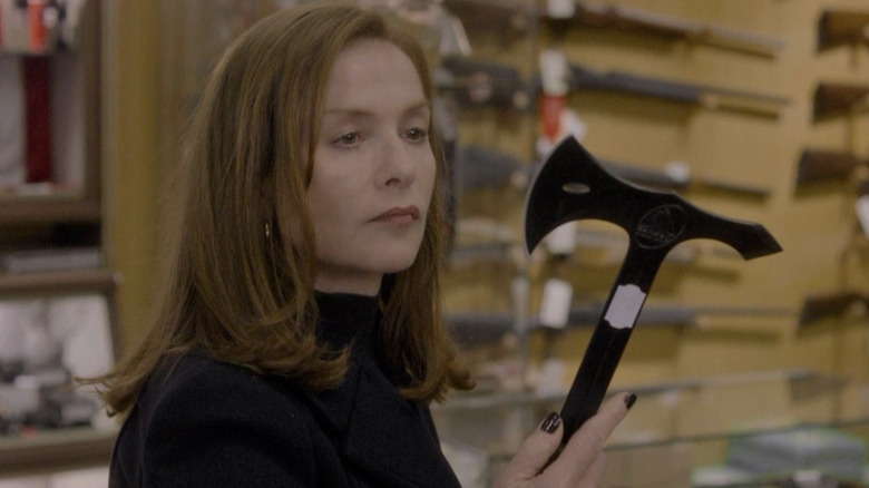 Isabelle Huppert as Michèle Leblanc holding as axe in Elle