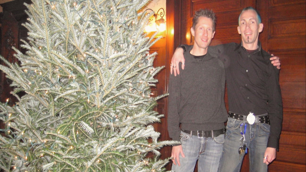 Joey Banis and Jeffrey Mundt in from of their Christmas tree months after the murder of Jamie Carroll in Murder in Glitterball City