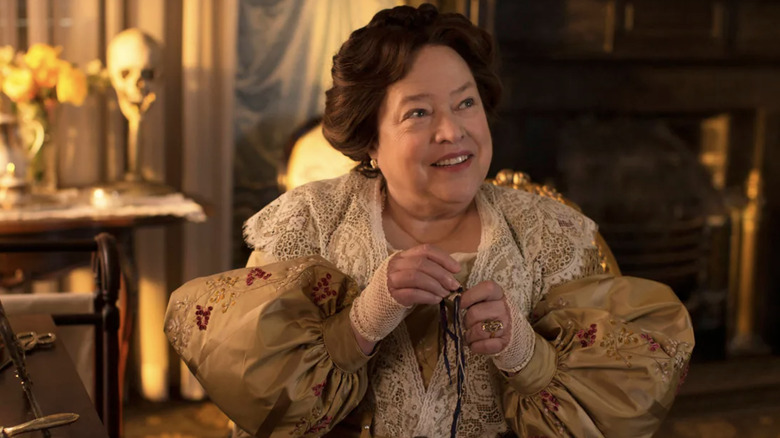 Kathy Bates as Delphine LaLaurie smiking in American Horror Story: Coven