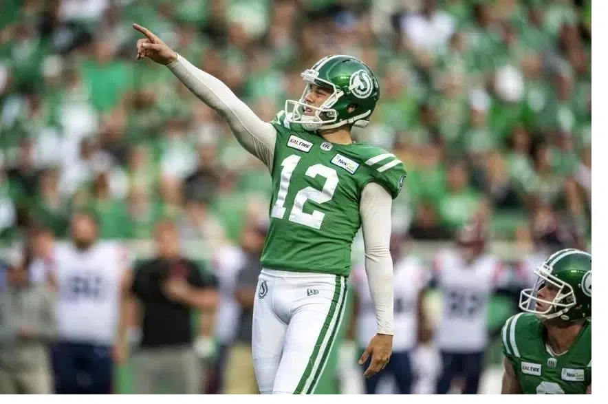 Kicker Brett Lauther points ahead of a kick during a CFL game.