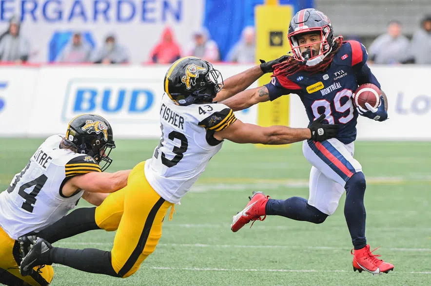 Montreal Alouettes' James Letcher Jr., (89) evades a tackle from Hamilton Tiger-Cats' Kyler Fisher (43) and Ante Milanovic-Litre (34) during second half CFL football action in Montreal, Saturday, Sept., 6, 2025.