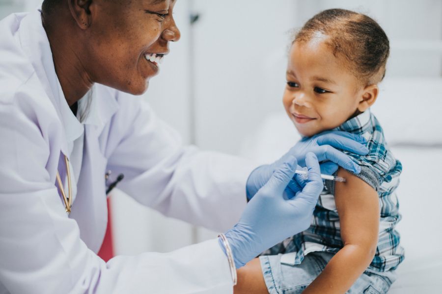 A stock image of a doctor giving a baby a vaccine in her arm.