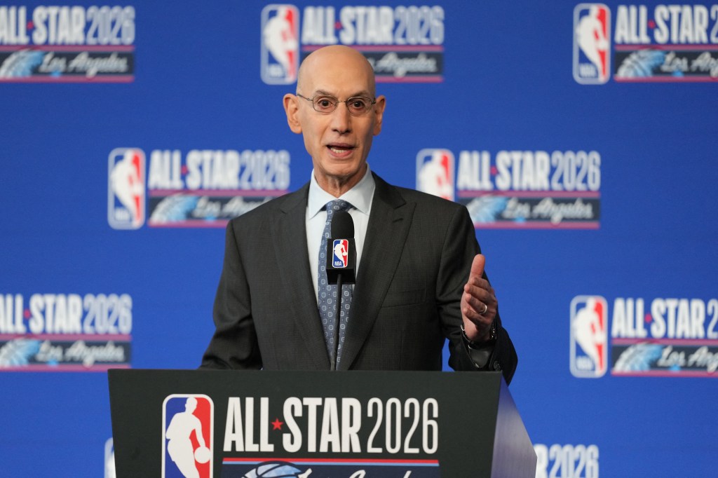 NBA commissioner Adam Silver speaks at a press conference with "ALL STAR 2026 Los Angeles" logos on the blue backdrop.
