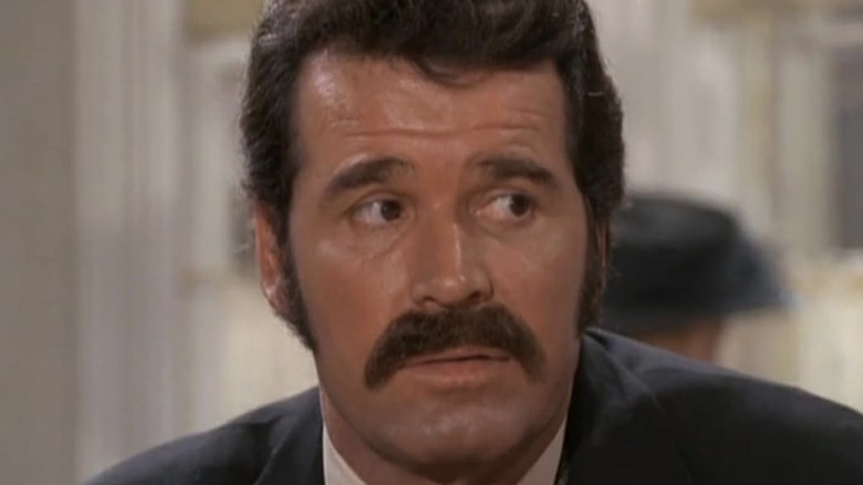 James Garner's Jim Nichols looks off to his left in closeup in Nichols