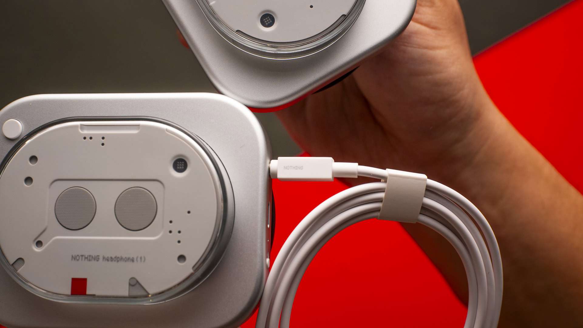 A photograph of the Nothing Headphone (1) ear cup and 3.5mm cable.