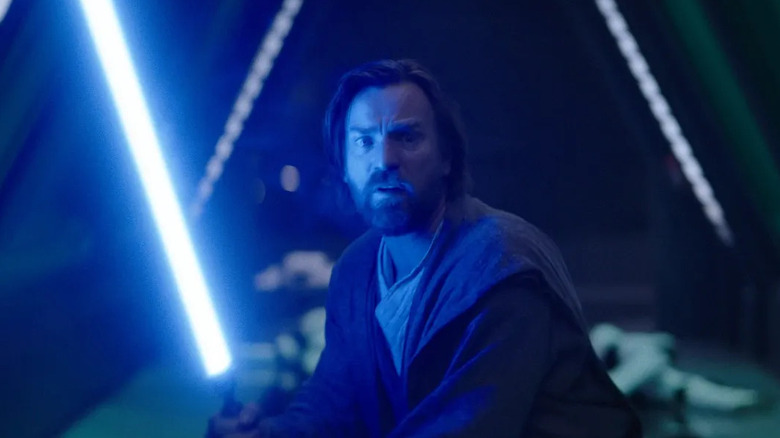 Ewan McGregor as Obi-Wan Kenobi holds a lightsaber in Obi-Wan Kenobi