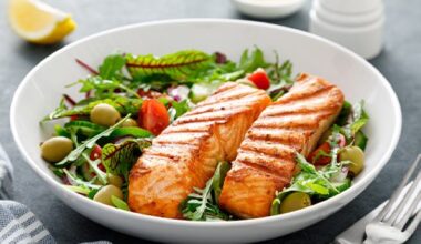 plate of salmon over salad