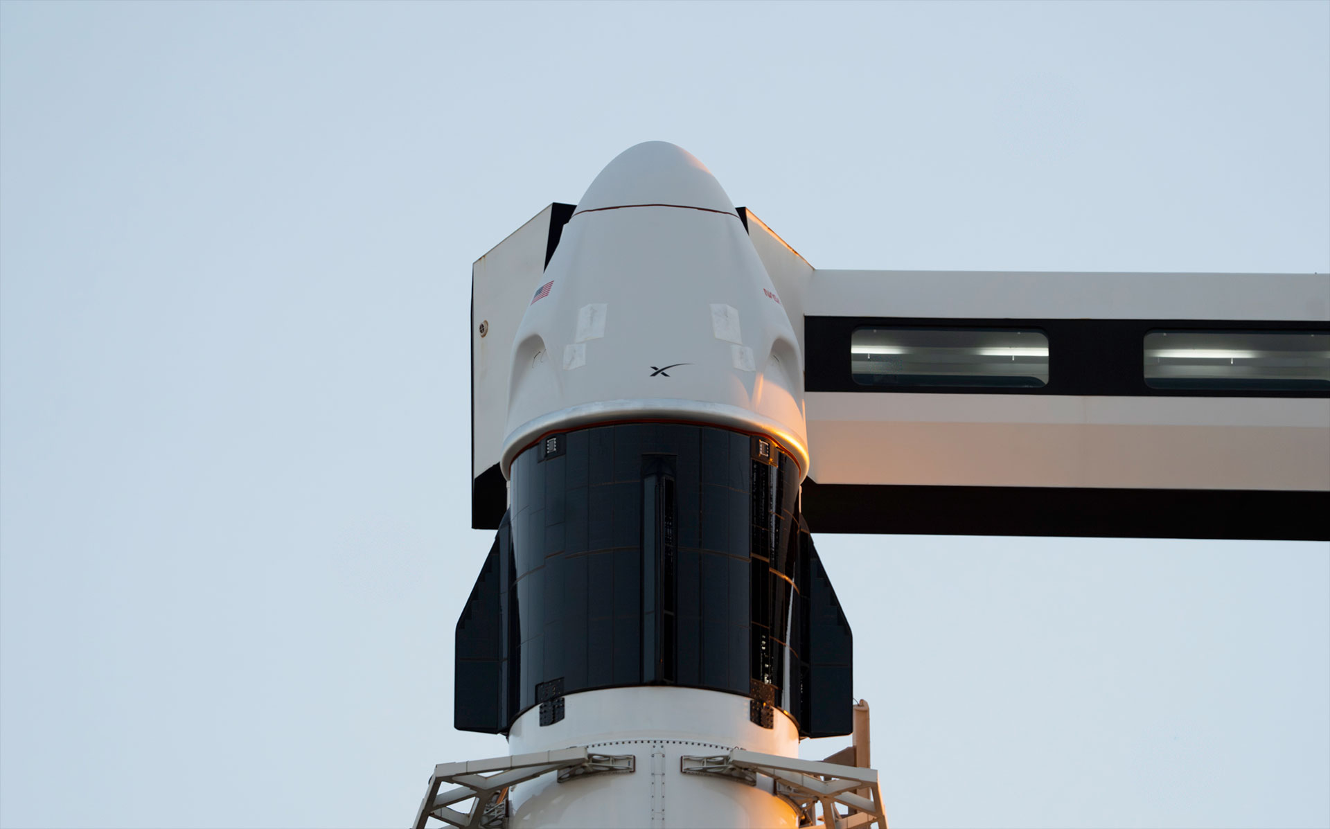 an access arm extends from a launch support tower providing a walkway and access bridge to a space capsule