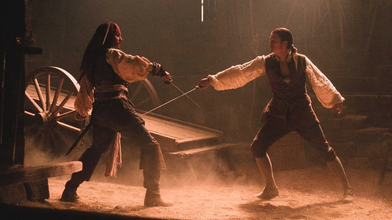 Johnny Depp as Jack Sparrow in a sword fight with Orlando Bloom as Will in Pirates of the Caribbean The Curse of the Black Pearl