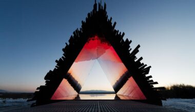 red chamber emerges from prism shelter’s charred wood shell