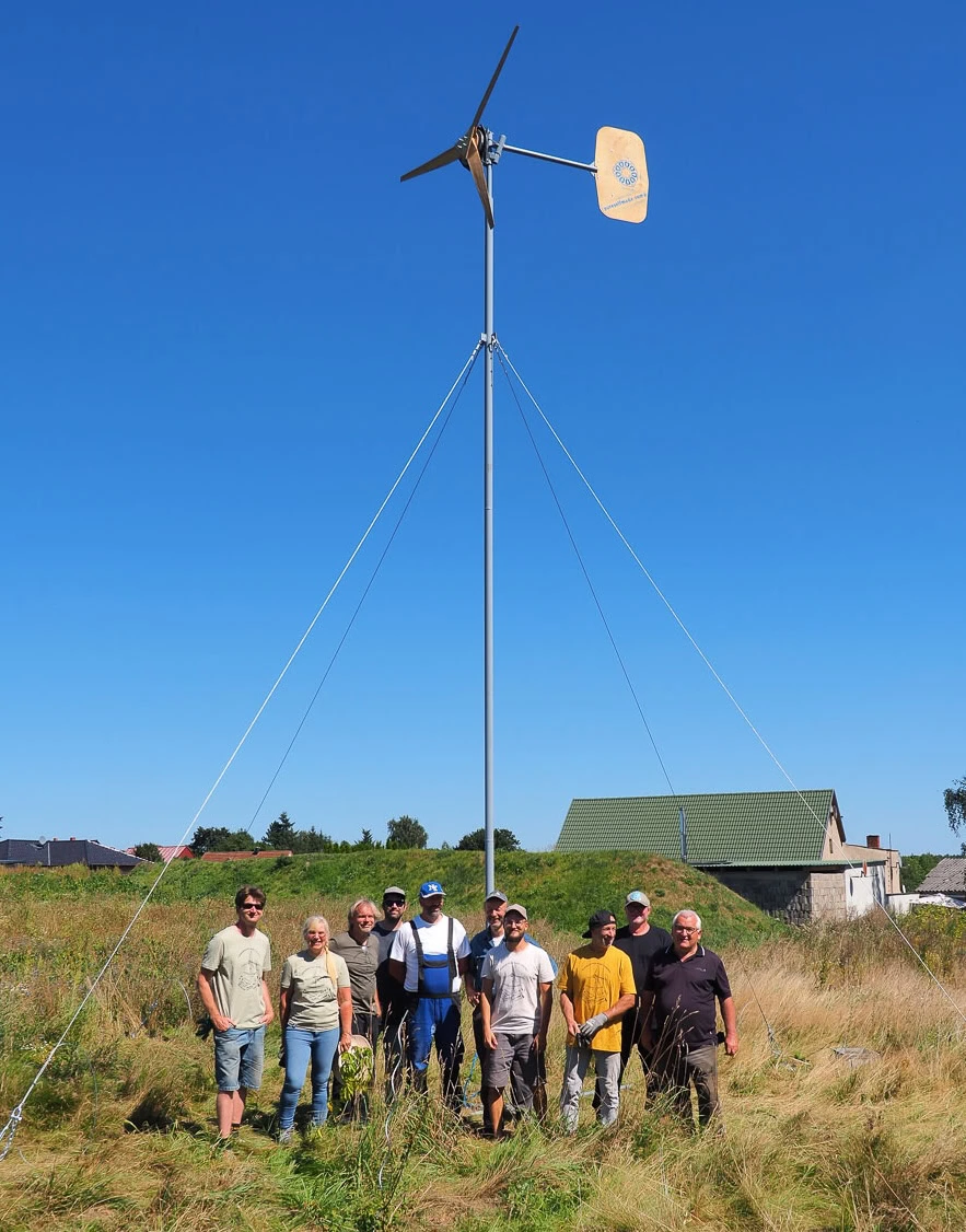 PureSelfMade participants in front of their newly-erected wind turbine