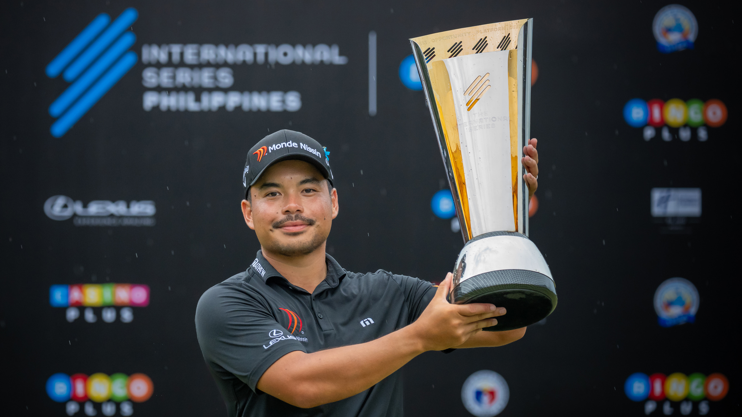 Miguel Tabuena poses with the International Series Philippines trophy after winning in 2025