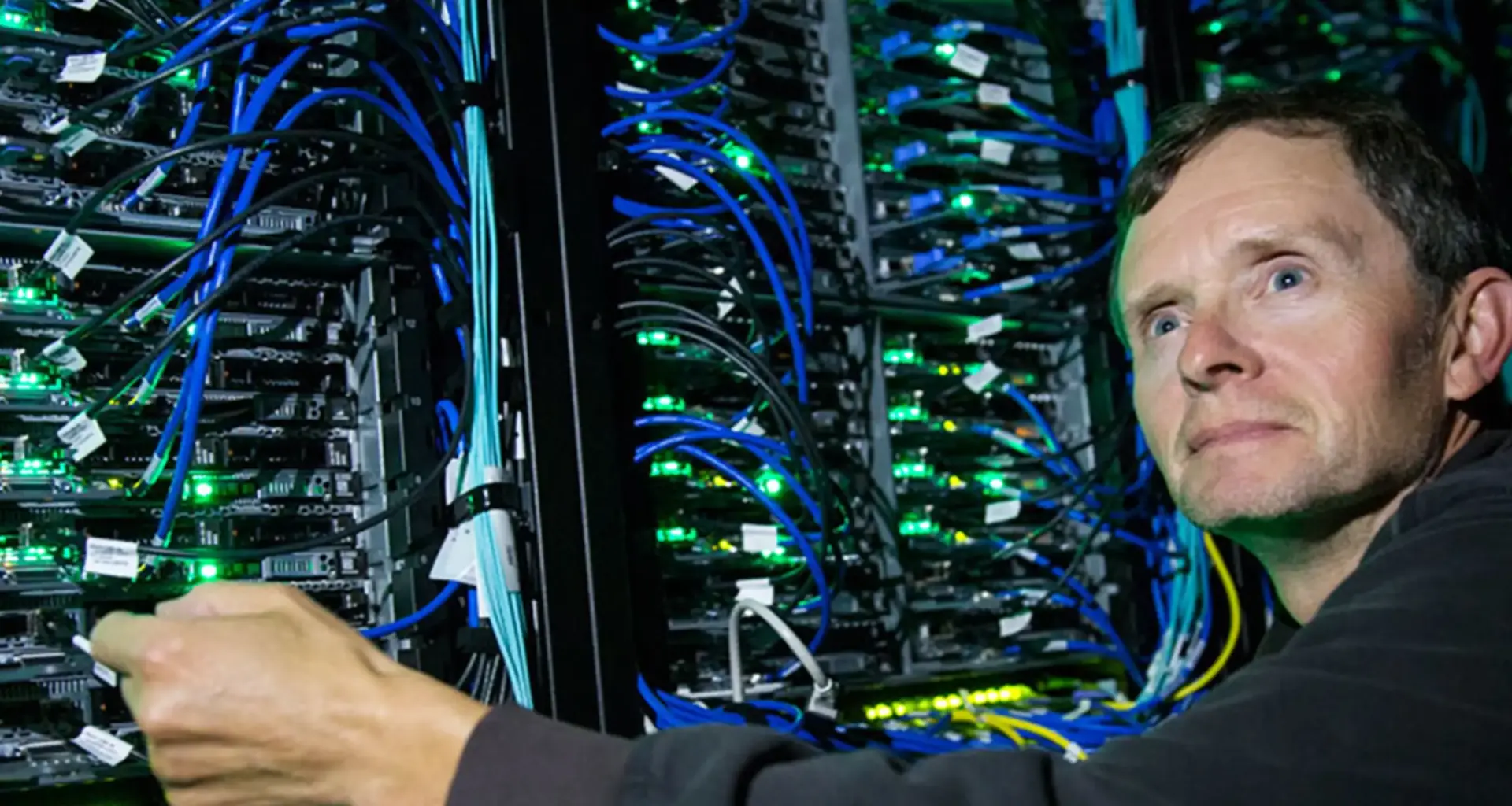 Randall Sobie stands in front of UVic’s Arbutus supercomputing infrastructure.