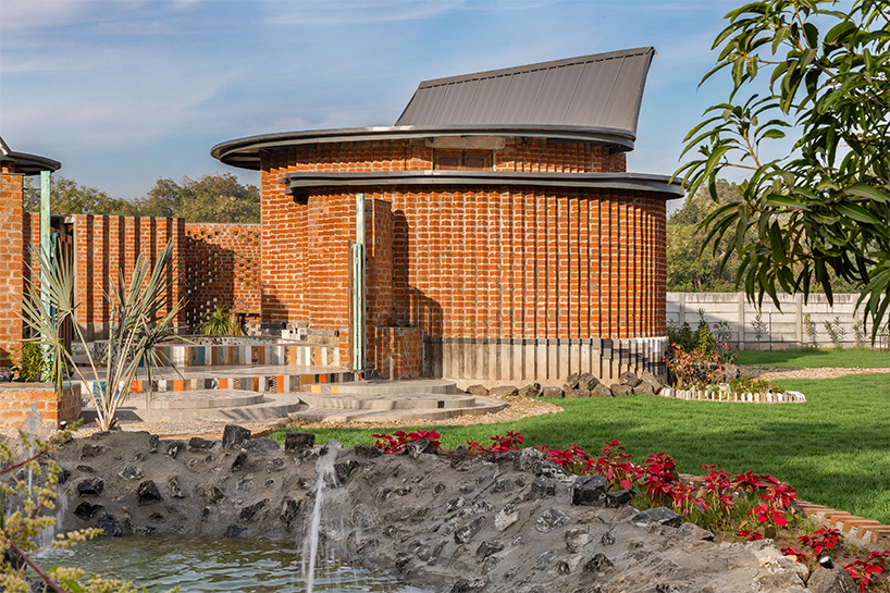 curved brick patterned walls frame farmhouse by manoj patel in india