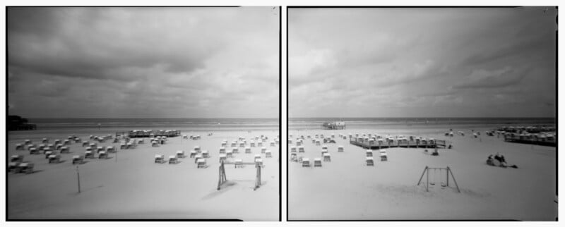 A black-and-white panoramic photo of a beach with numerous empty beach chairs arranged in rows on the sand under a cloudy sky; a few swings and scattered groups of people are visible.