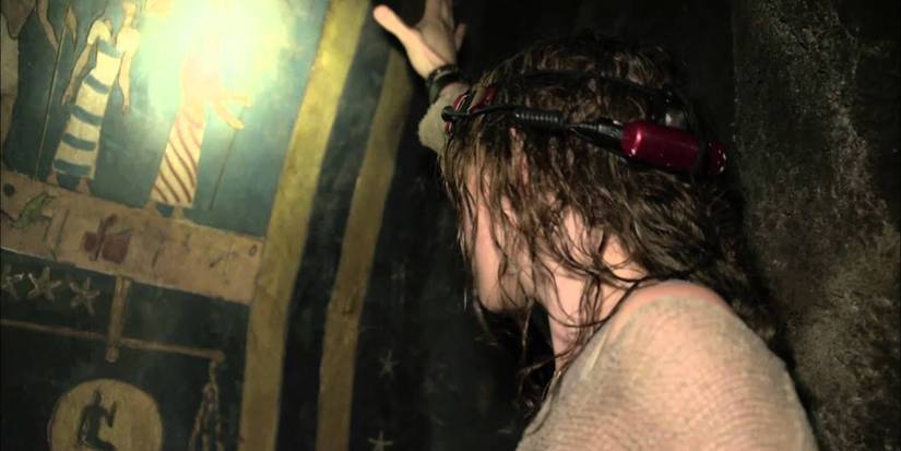 Scarlett (Perdita Weeks) inspects the wall of a tomb in As Above, So Below