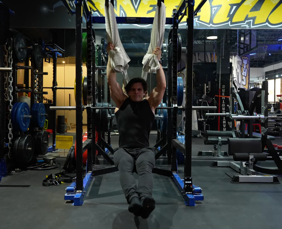 individual performing a workout using a gym apparatus individual performing a workout using a gym apparatus