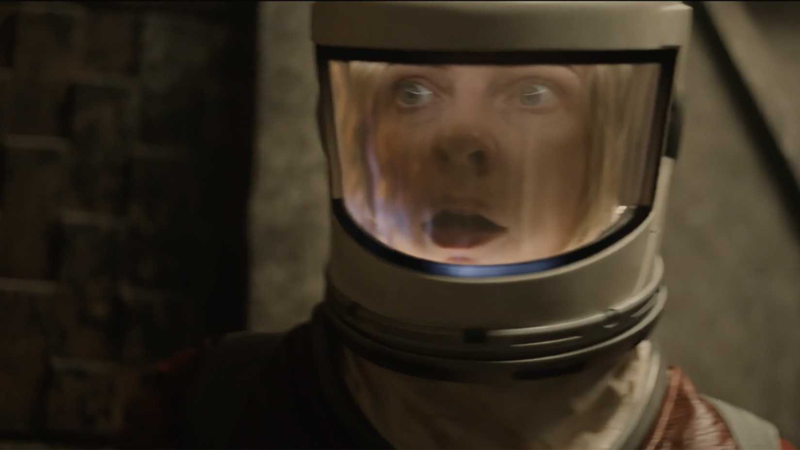 Juliette in a suit looking surprised in Silo.