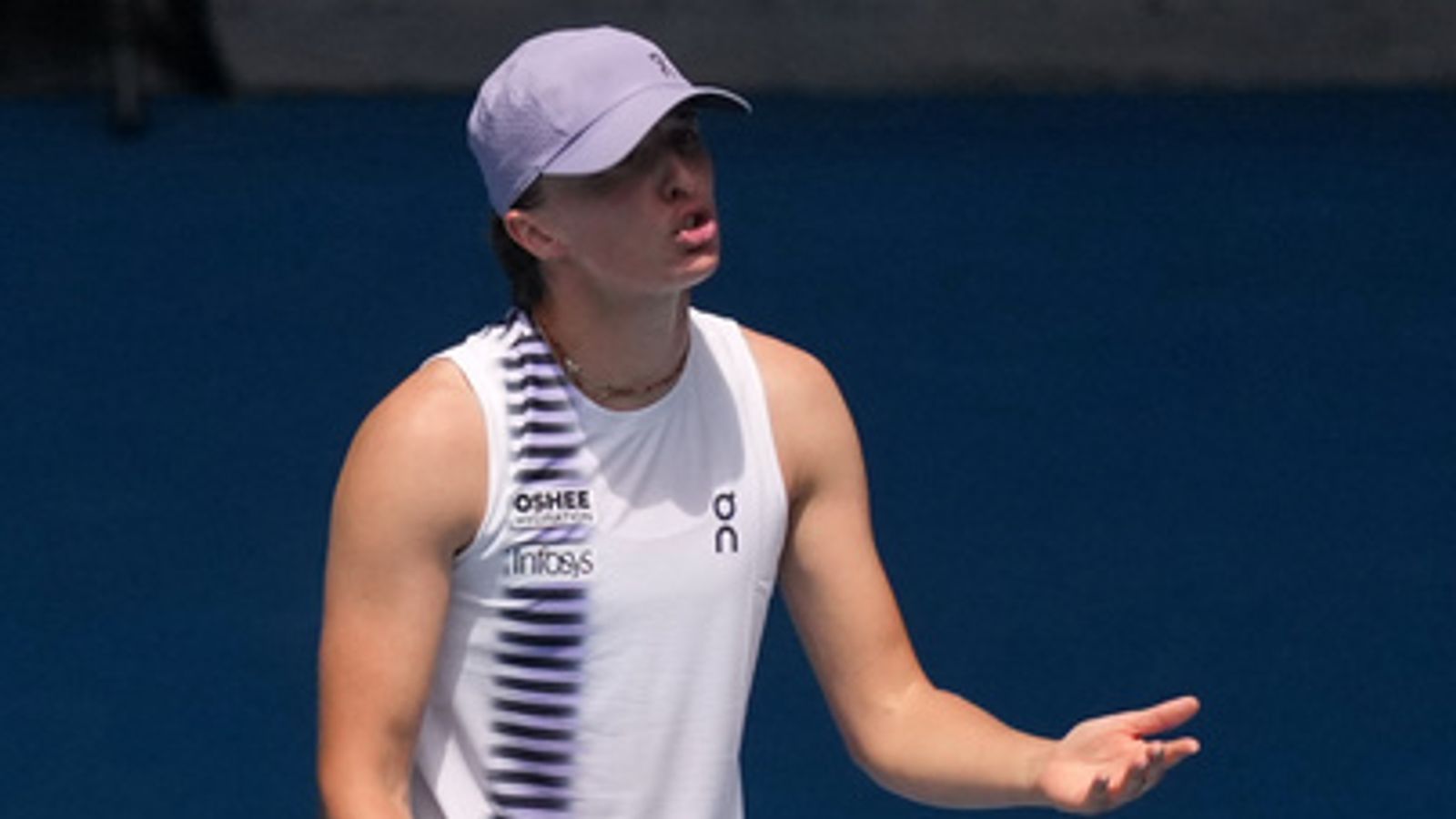 Iga Swiatek of Poland gestures as she questions a line call during her quarterfinal against Elena Rybakina of Kazakhstan at the Australian Open tennis championship in Melbourne, Australia, Wednesday, Jan. 28, 2026. (AP Photo/Asanka Brendon Ratnayake)