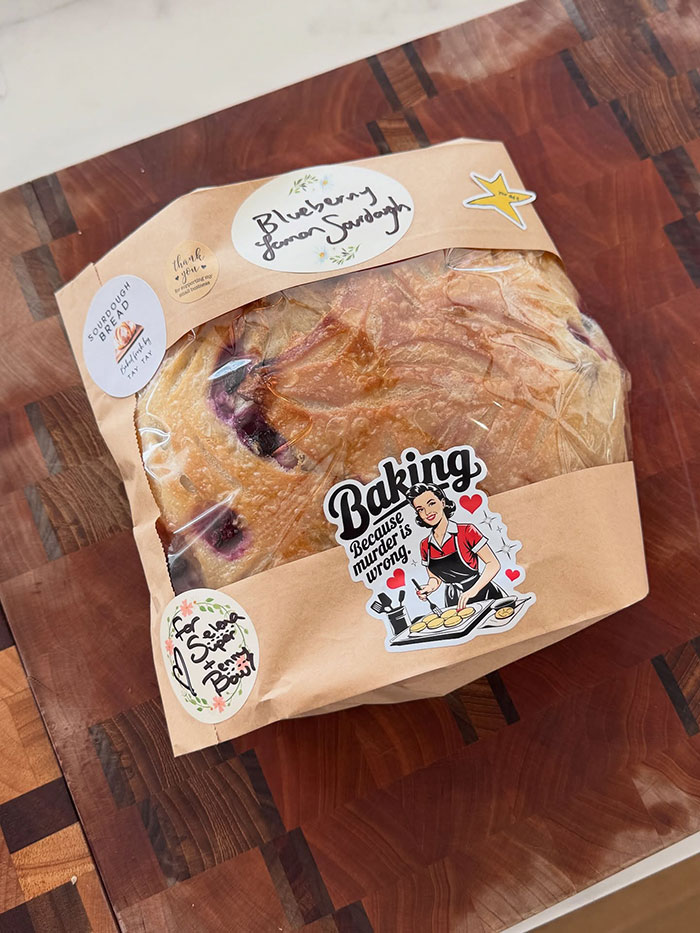 Blueberry lemon sourdough bread gift wrapped on a wooden cutting board, linked to Taylor Swift and Selena Gomez backlash. Blueberry lemon sourdough bread gift wrapped on a wooden cutting board, linked to Taylor Swift and Selena Gomez backlash.