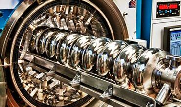 Multiple gold rings of various sizes that is an SQMS superconducting cavity.