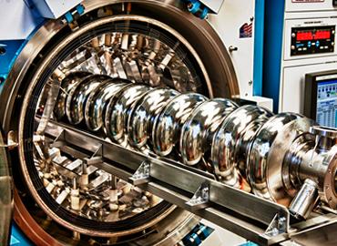Multiple gold rings of various sizes that is an SQMS superconducting cavity.