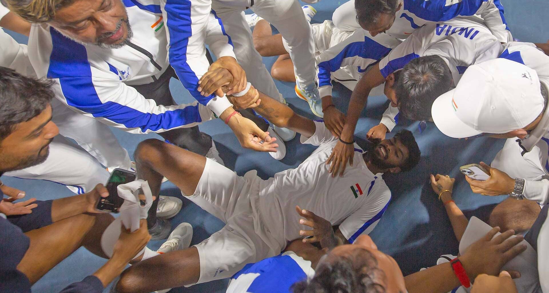 Dhakshineswar Suresh is congratulated by his teammates after securing a famous Davis Cup win for India.