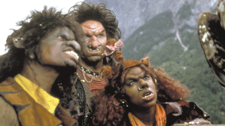 Three trolls looking up at hawk with mountains in the background in The 10th Kingdom