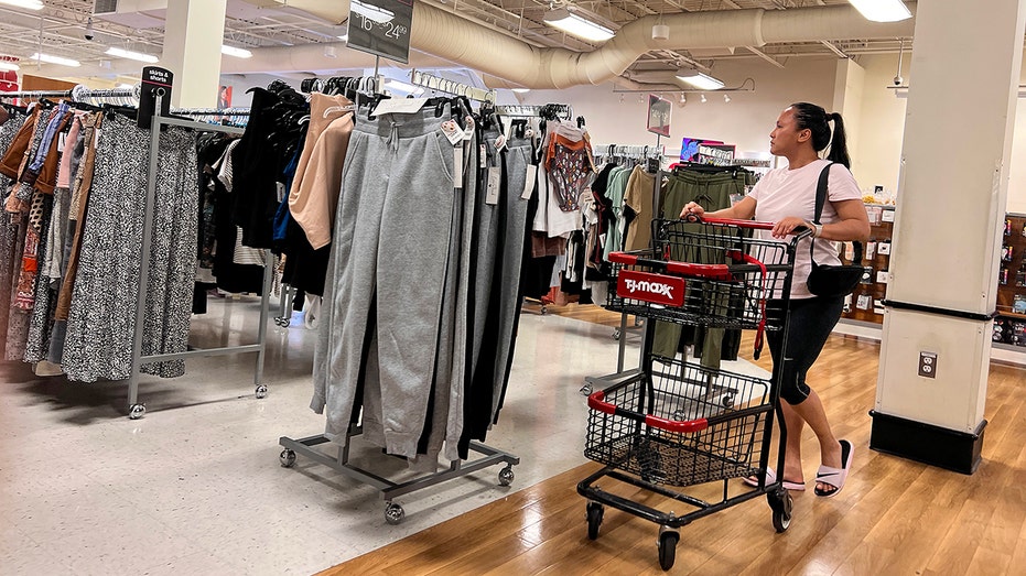 Woman pushes cart at TJ Maxx store