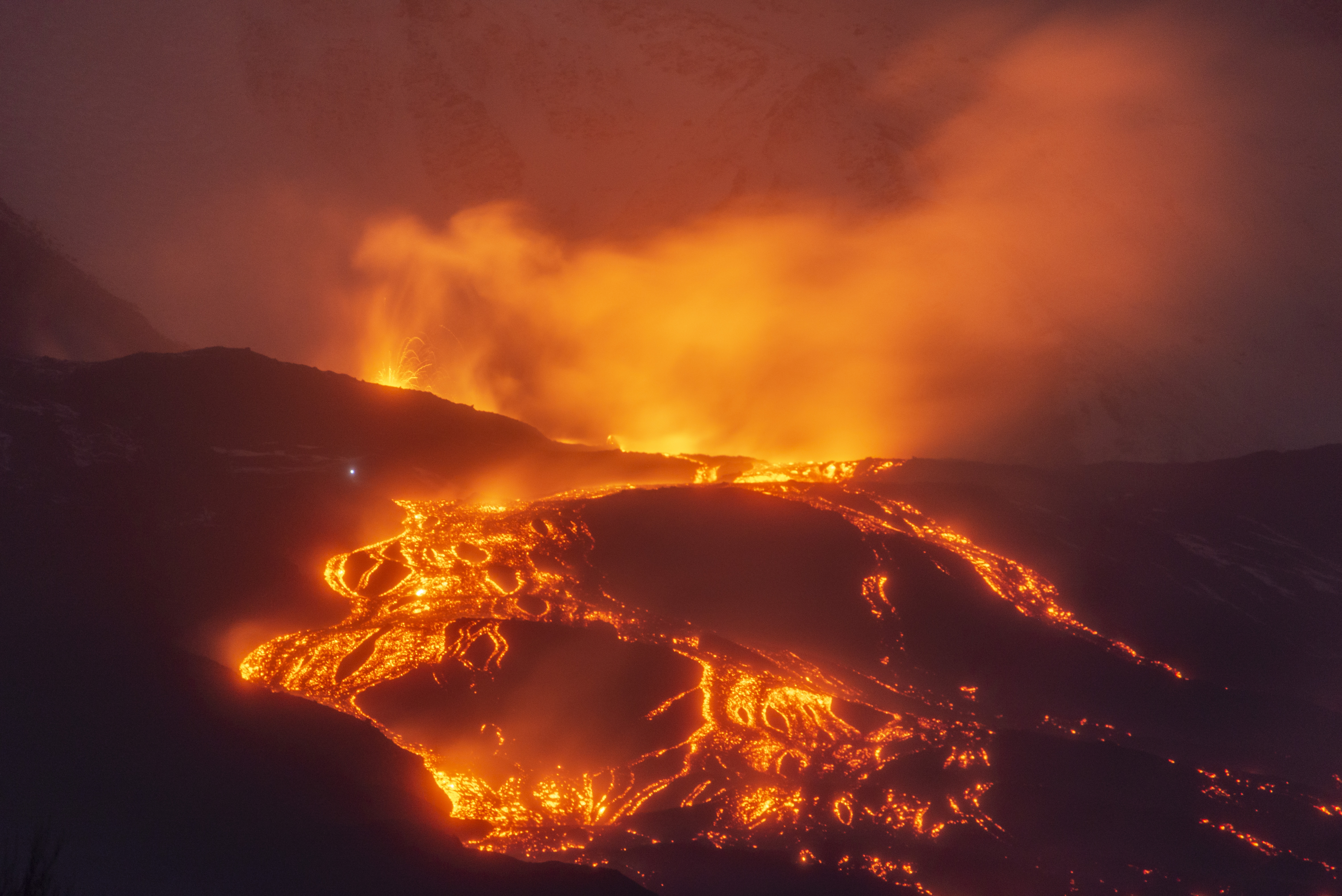 Mount Etna lava flow continues as new fissure opens on eastern flank.