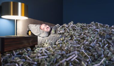 A person sleeps while surrounded by cash bundles.