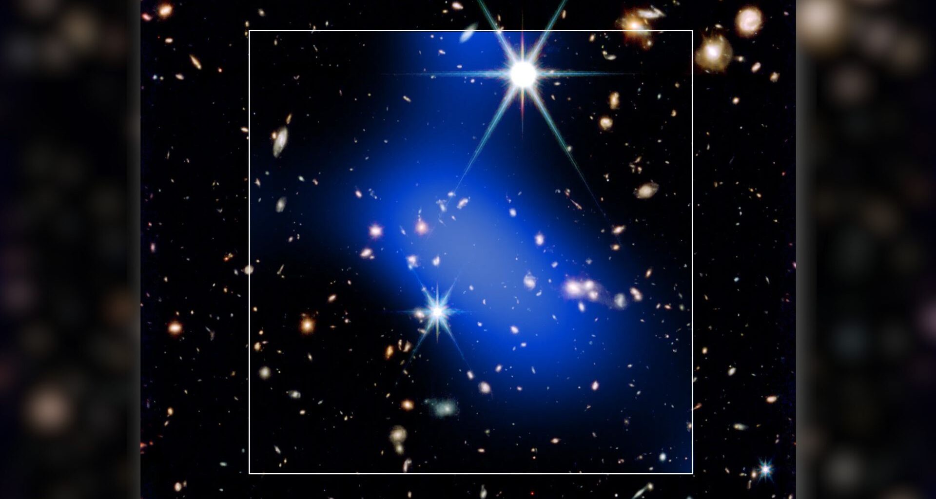 A bright blue streak of light is seen covering a series of bright stars in this dark deep space image. A white box surrounds the blue shape