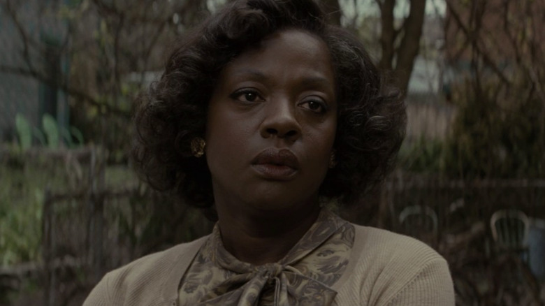 Viola Davis as Rose Lee Maxson looking serious and standing outside in Fences