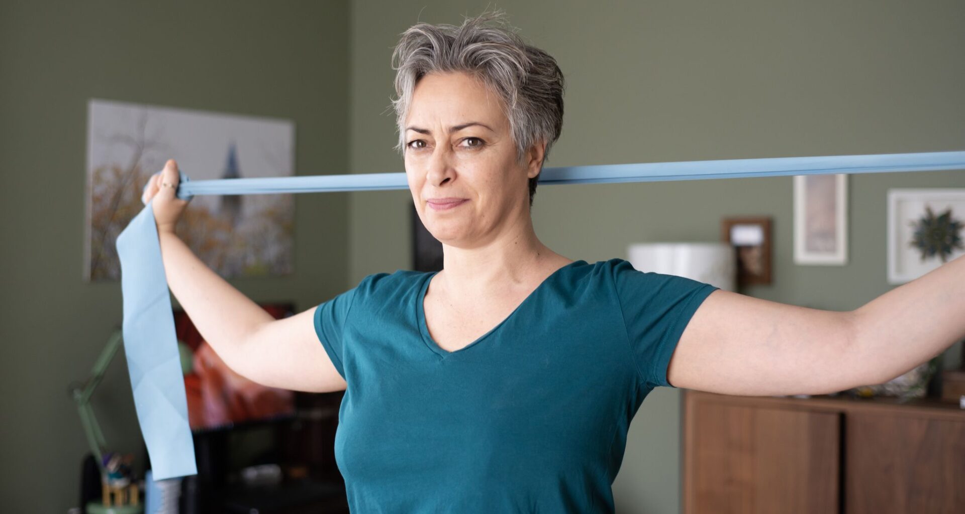 If you work at a desk, a Pilates teacher recommends these three yoga strap moves to loosen up hunched shoulders