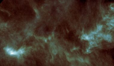 a pale green cloud of gas on a starry background