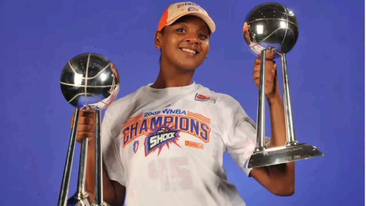 WNBA star Kara Braxton poses with two championship trophies in 2008 (Garrett Ellwood/NBAE via Getty) WNBA star Kara Braxton poses with two championship trophies in 2008.