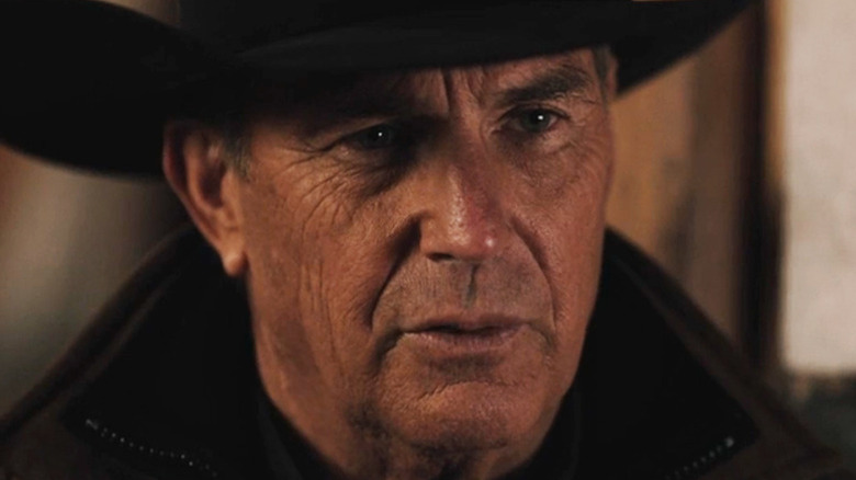 John Dutton III (Kevin Costner) stands solemnly in Yellowstone