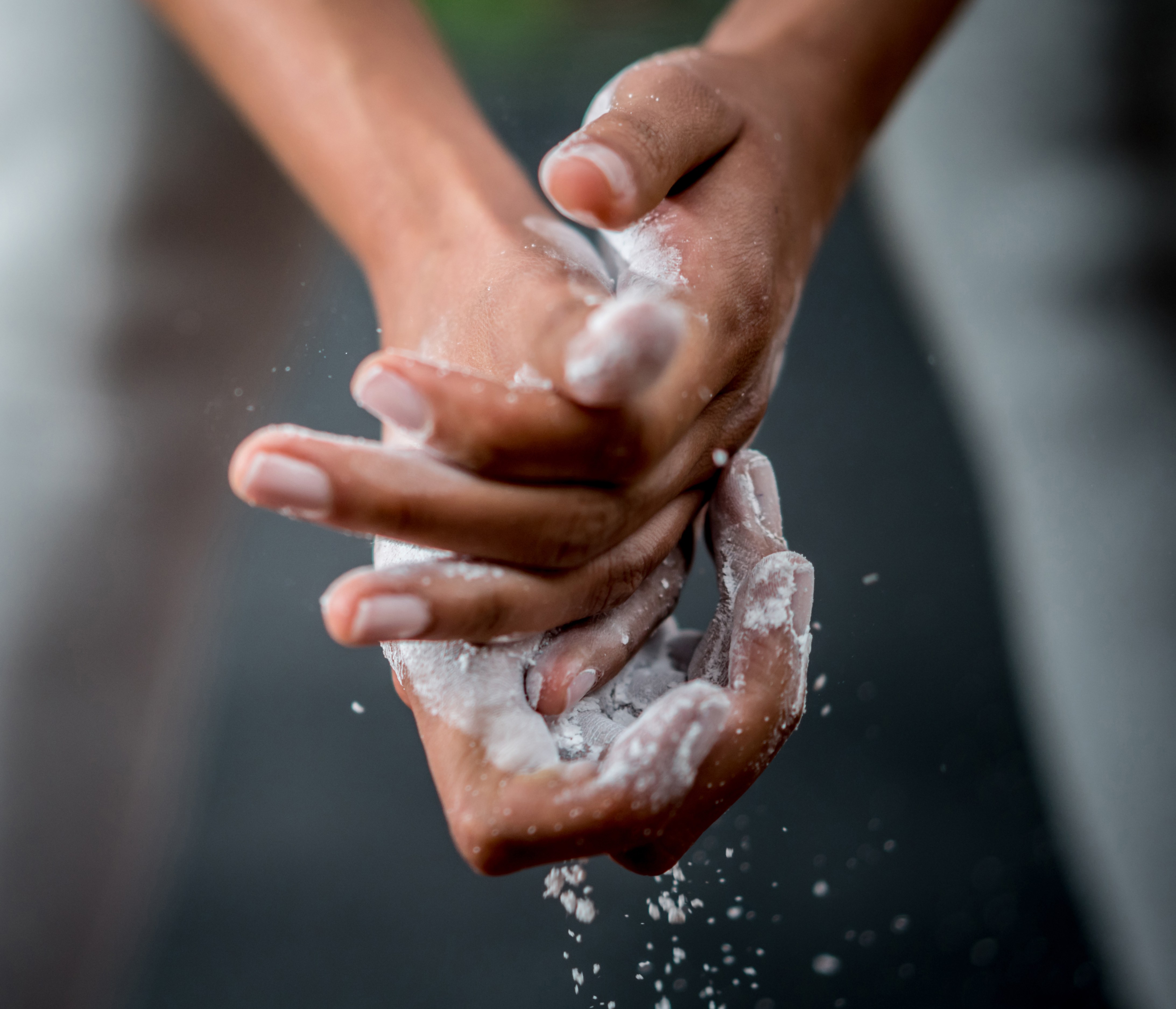 Woman at the gym putting powder in her hands