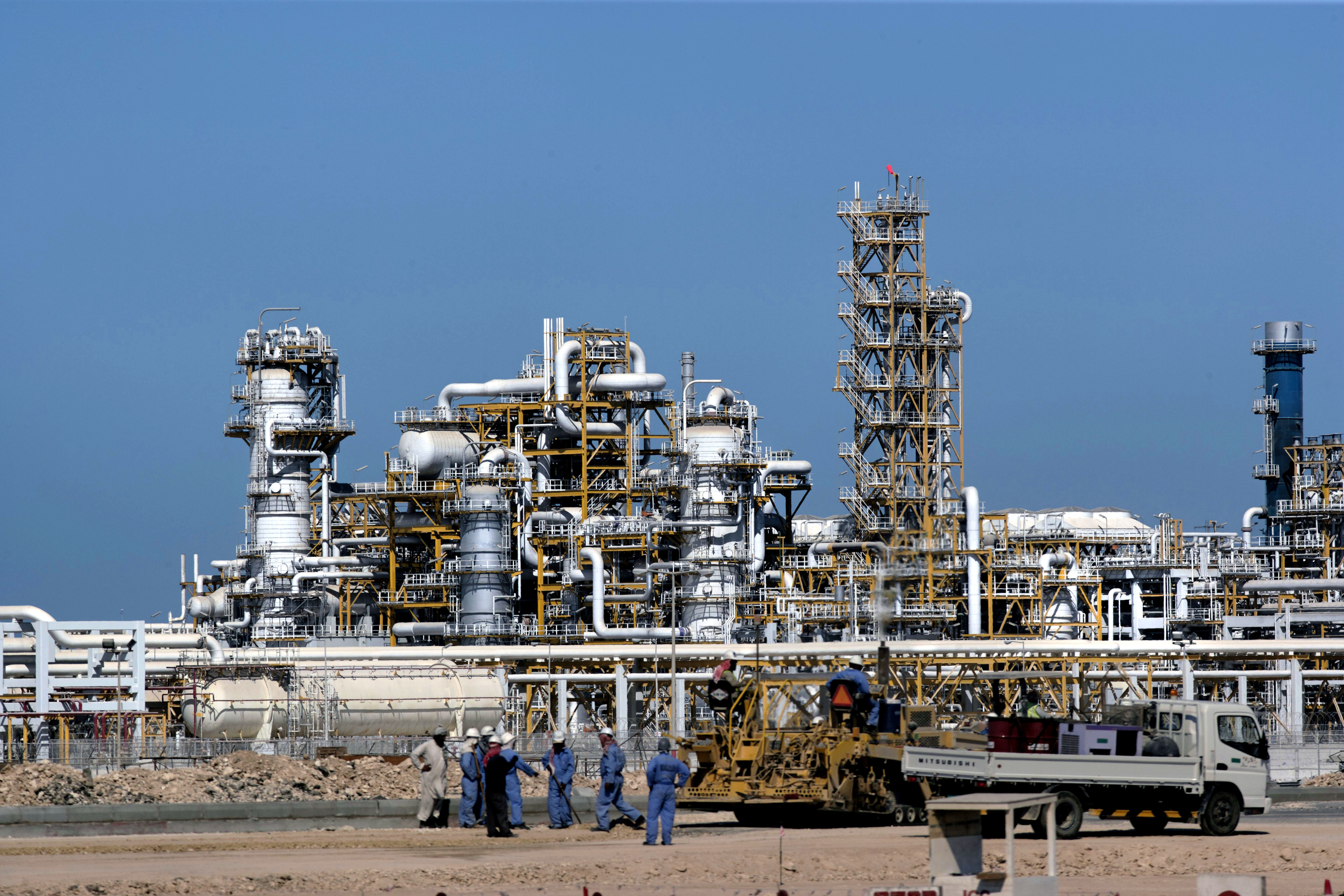 Workers and machinery at the Ras Laffan natural gas liquefaction plant in Qatar.