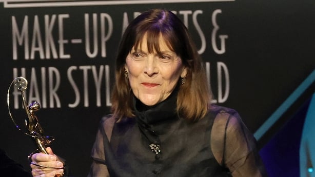 BEVERLY HILLS, CALIFORNIA - FEBRUARY 19: Michèle Burke, winner of the Lifetime Achievement Award for Make-Up, speaks onstage during the 9th Annual Make-Up Artists & Hair Stylists Guild Awards at The Beverly Hilton on February 19, 2022 in Beverly Hills, California. (Photo by Kevin Winter/Getty Images
