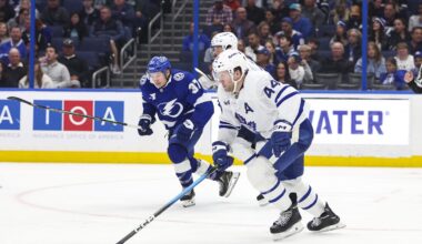 Feb 25, 2026; Tampa, Florida, USA; Toronto Maple Leafs defenseman Morgan Rielly (44) skates with the puck with Tampa Bay Lightning forward Yanni Gourde (37) behind him during the third period at Benchmark International Arena. Mandatory Credit: Morgan Tencza-Imagn Images