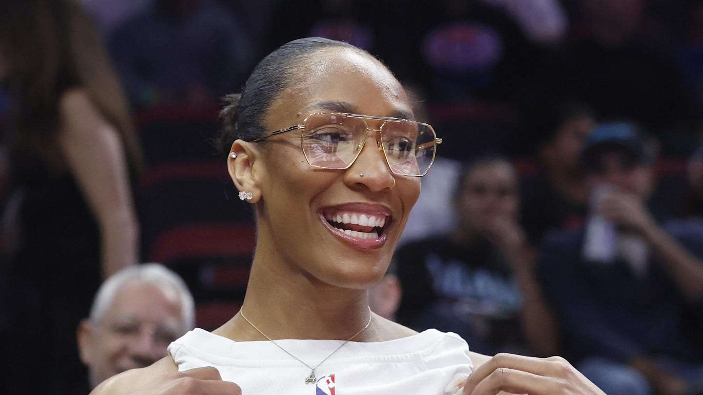 Nov 19, 2025; Miami, Florida, USA; WNBA player A'ja Wilson shows off her Miami Heat Bam Adebayo jersey before the game between the Miami Heat and the Golden State Warriors at Kaseya Center. Mandatory Credit: Rhona Wise-Imagn Images