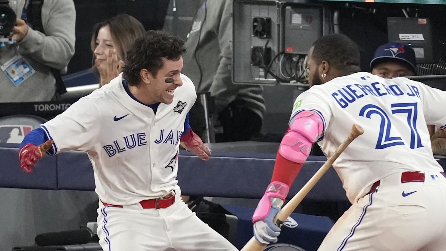 Nov 1, 2025; Toronto, Ontario, CAN; Toronto Blue Jays third baseman Ernie Clement (22) celebrates with first baseman Vladimir Guerrero Jr. (27) after scoring against the Los Angeles Dodgers in the sixth inning during game seven of the 2025 MLB World Series at Rogers Centre. Mandatory Credit: Kevin Sousa-Imagn Images
