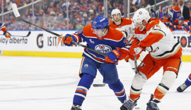 Mar 28, 2026; Edmonton, Alberta, CAN; Edmonton Oilers forward Matt Savoie (22) and Anaheim Ducks defensemen John Carlson (74) battle for a loose puck during the third period at Rogers Place. Mandatory Credit: Perry Nelson-Imagn Images